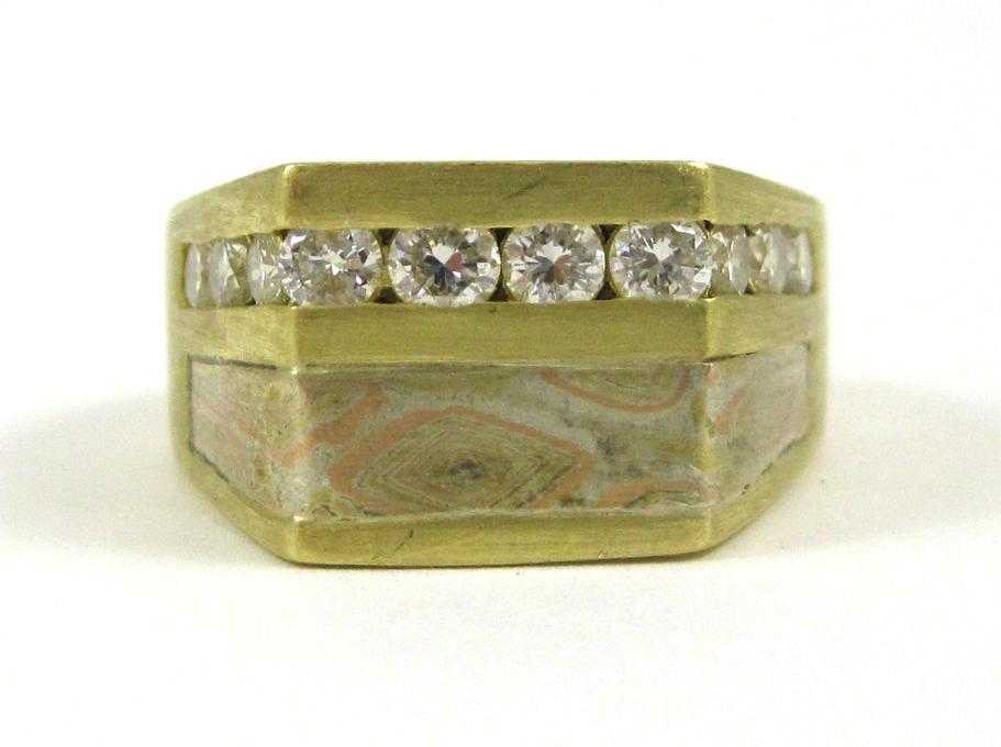 Appraisal: DIAMOND AND EIGHTEEN KARAT GOLD RING channel set with a