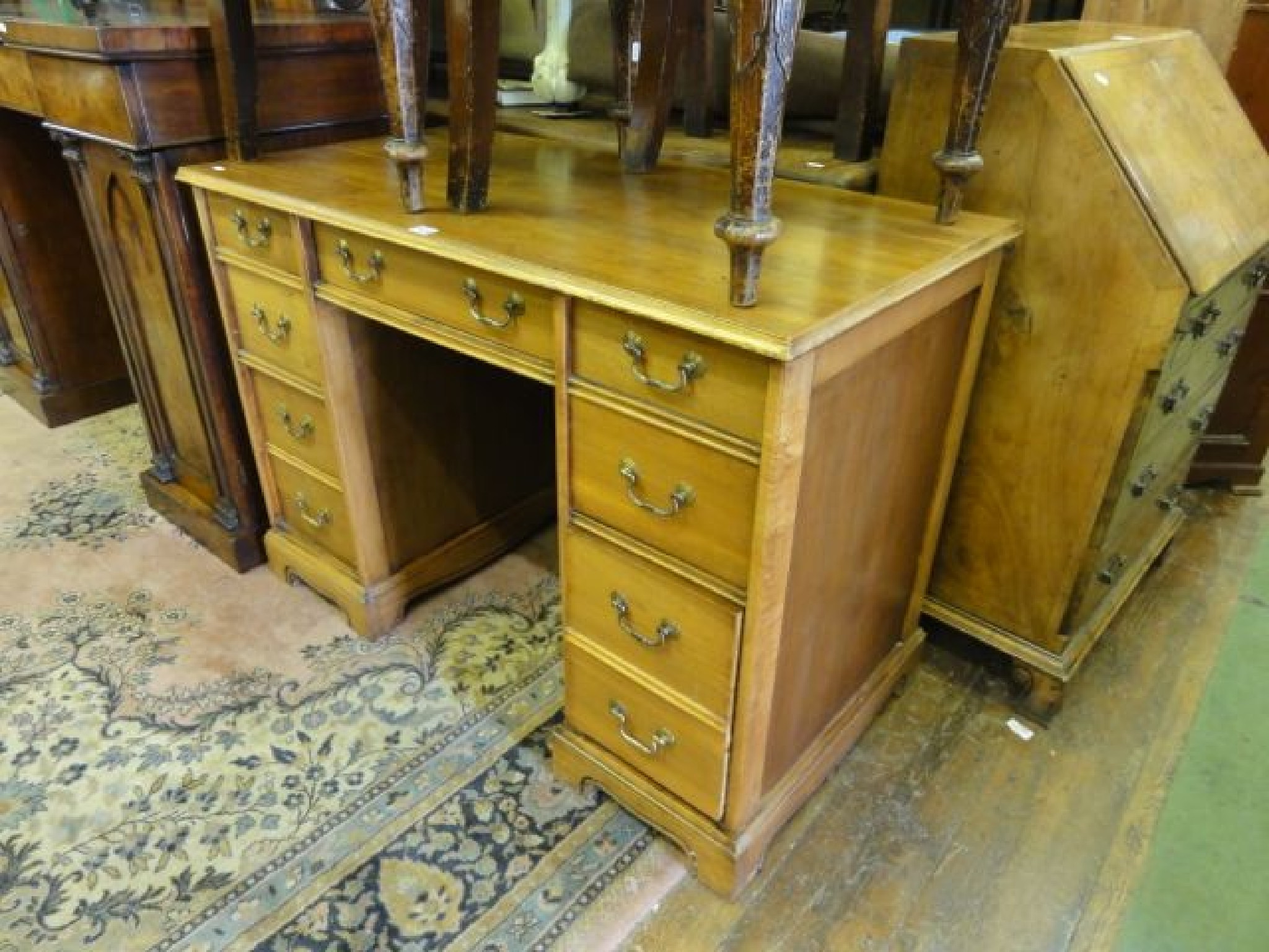 Appraisal: A walnut kneehole twin pedestal desk in the Georgian style