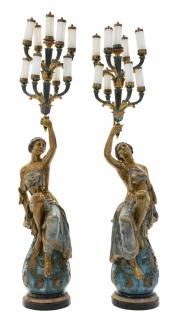 Appraisal: A PAIR OF CONTINENTAL STYLE PATINATED METAL FIGURAL NINE-LIGHT TORCHERES