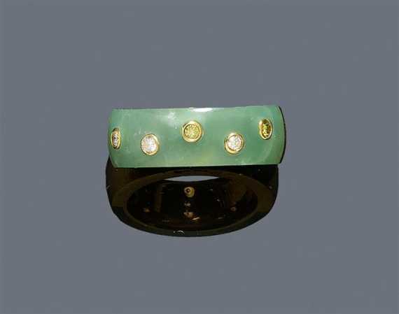 Appraisal: JADEITE AND DIAMOND RING Yellow gold Decorative band ring the