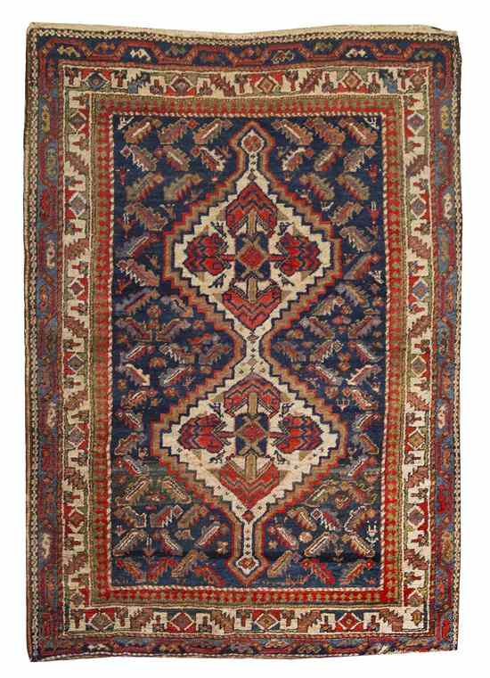 Appraisal: A Heriz Wool Rug having double diamond form medallions on