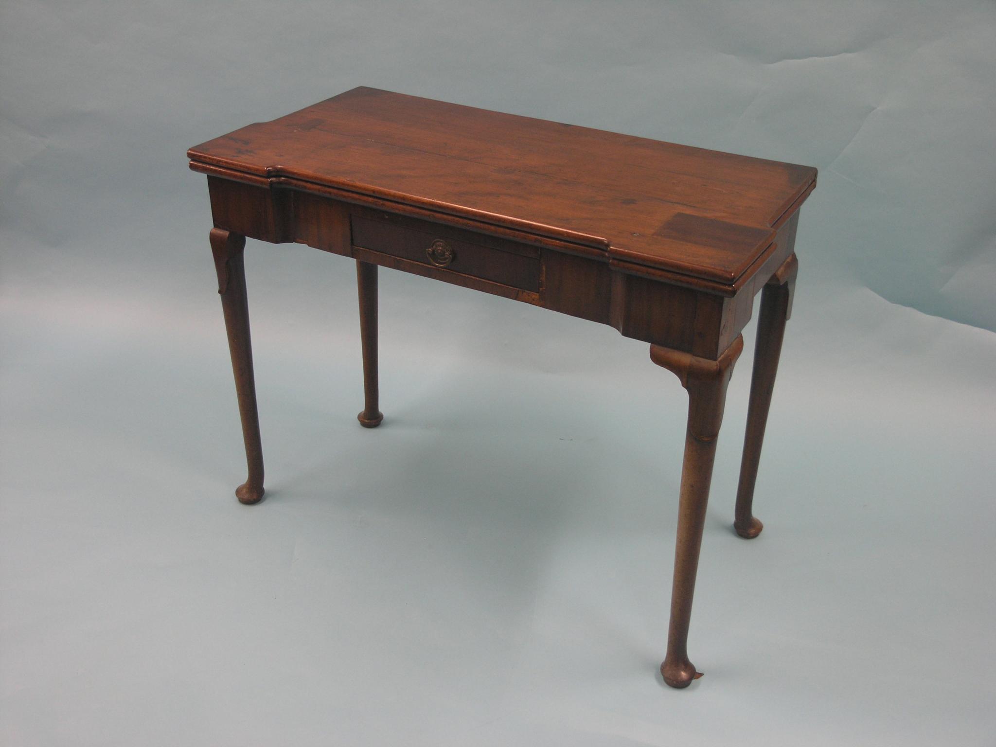 Appraisal: A George II mahogany card table rectangular top enclosing square