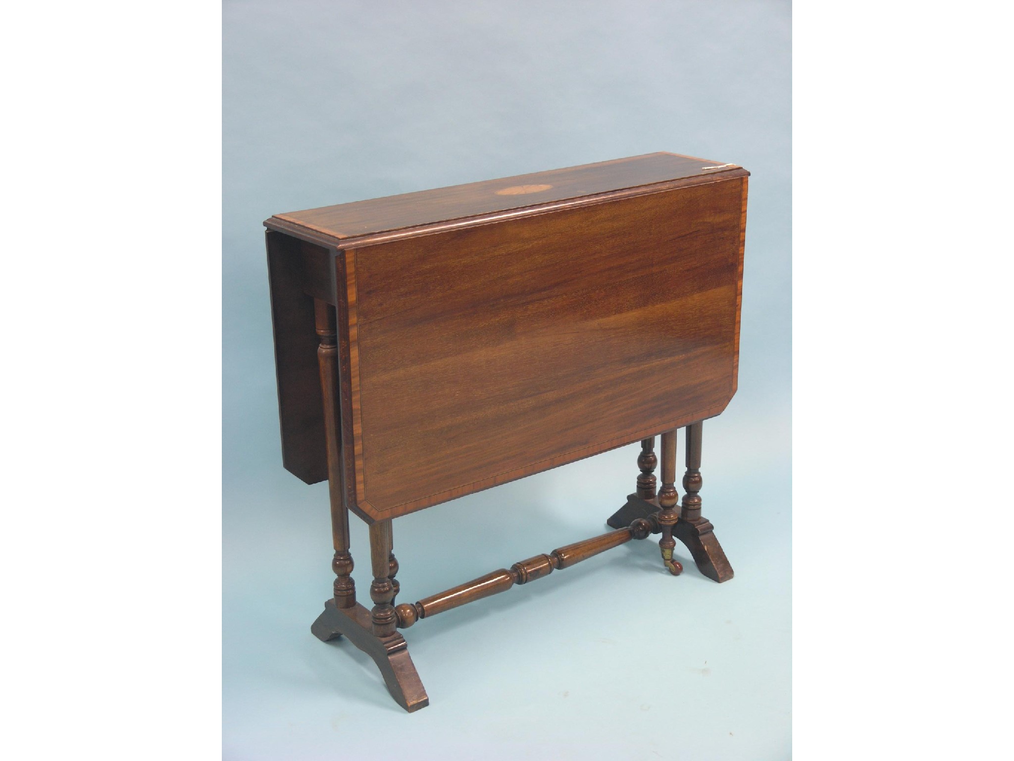 Appraisal: An Edwardian inlaid mahogany Sutherland table on turned underframe fly-legs