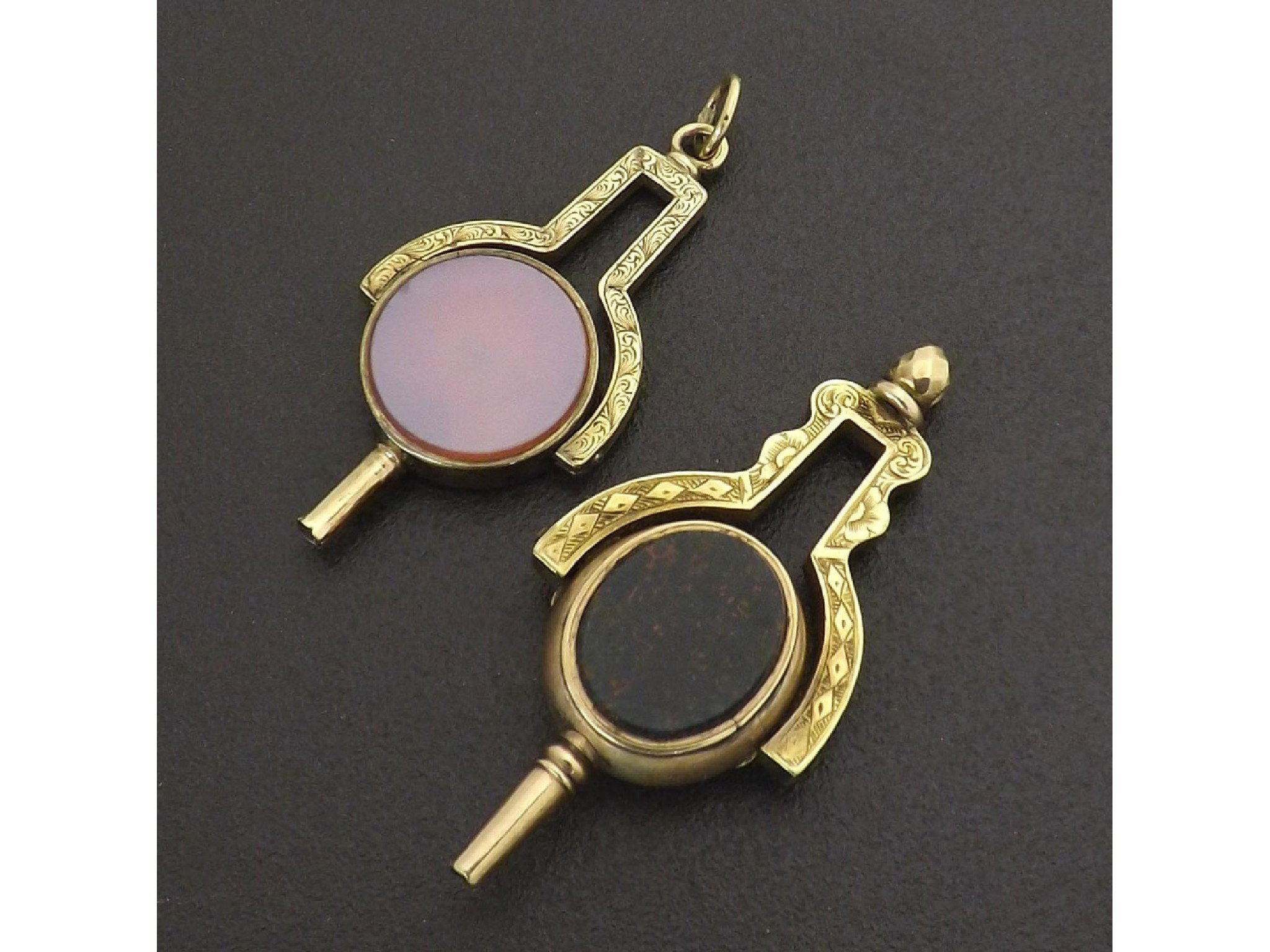 Appraisal: Two similar engraved gold revolving stone set pocket watch keys