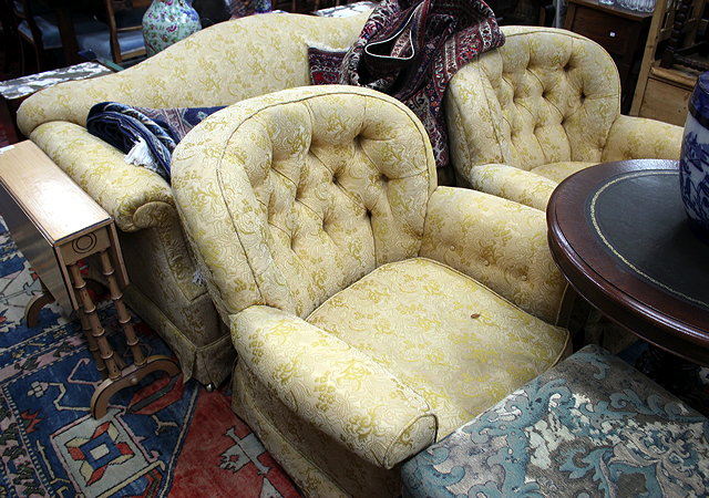 Appraisal: A THREE SEATER SETTEE with shaped back and rolled arms