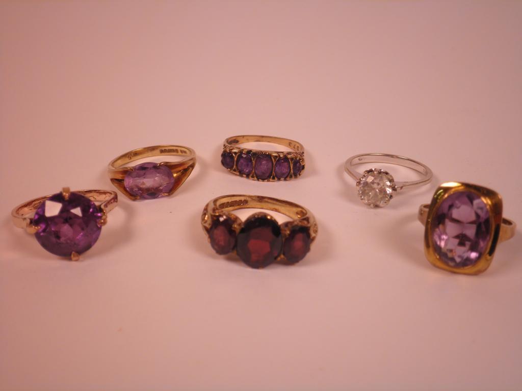 Appraisal: Four amethyst and gold rings a garnet ring and a