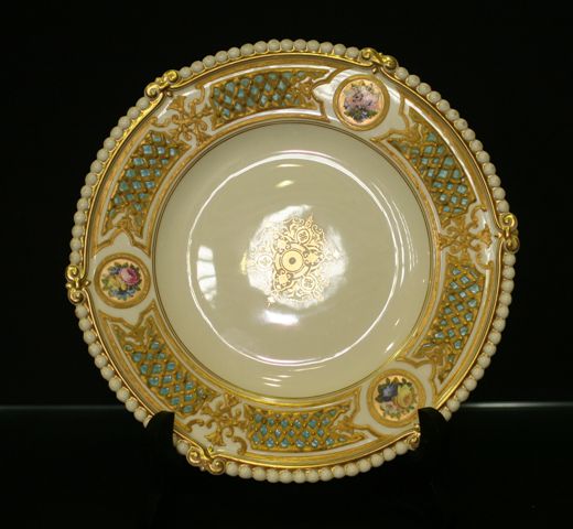 Appraisal: An English plate painted with roundels of floral bouquets within