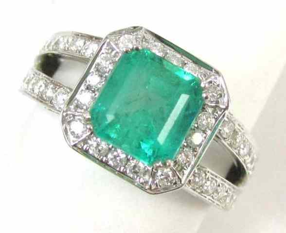 Appraisal: EMERALD DIAMOND AND WHITE GOLD RING round brilliant-cut diamonds are