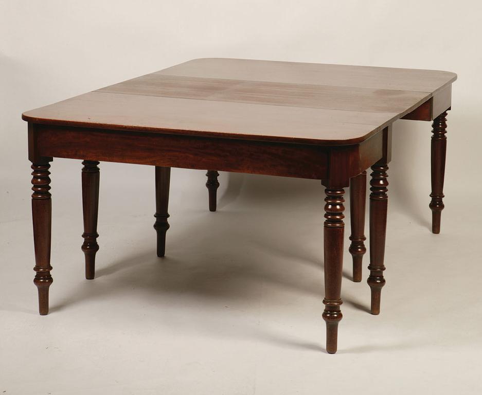 Appraisal: A REGENCY MAHOGANY DINING TABLE the twin ends with rounded