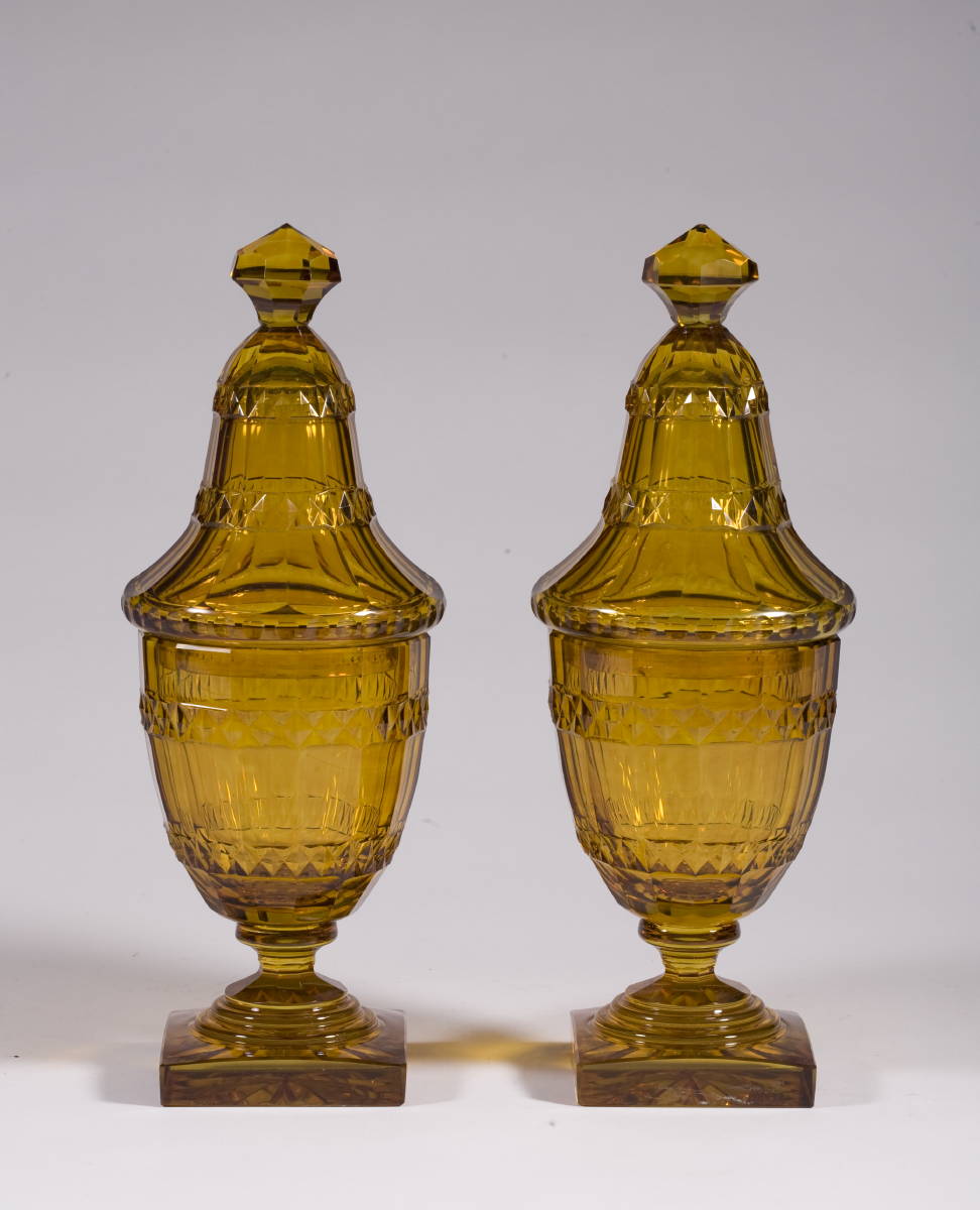 Appraisal: PAIR OF AMBER PANEL CUT GLASS COVERED SWEET MEAT JARS