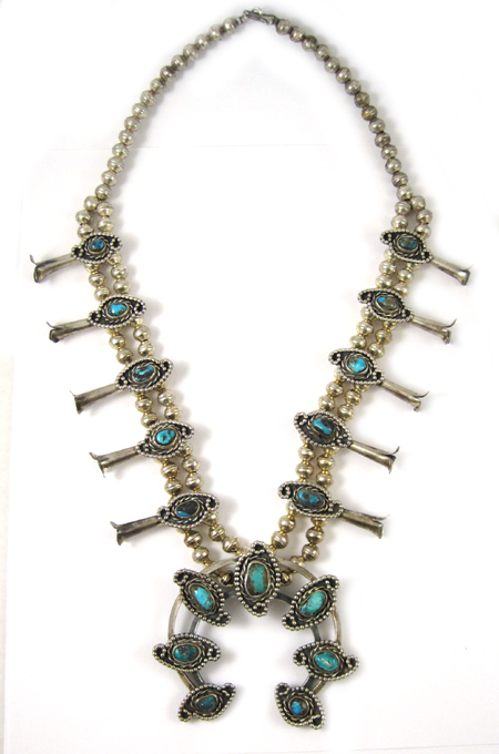 Appraisal: NAVAJO SQUASH BLOSSOM NECKLACE featuring silver blossoms each set with