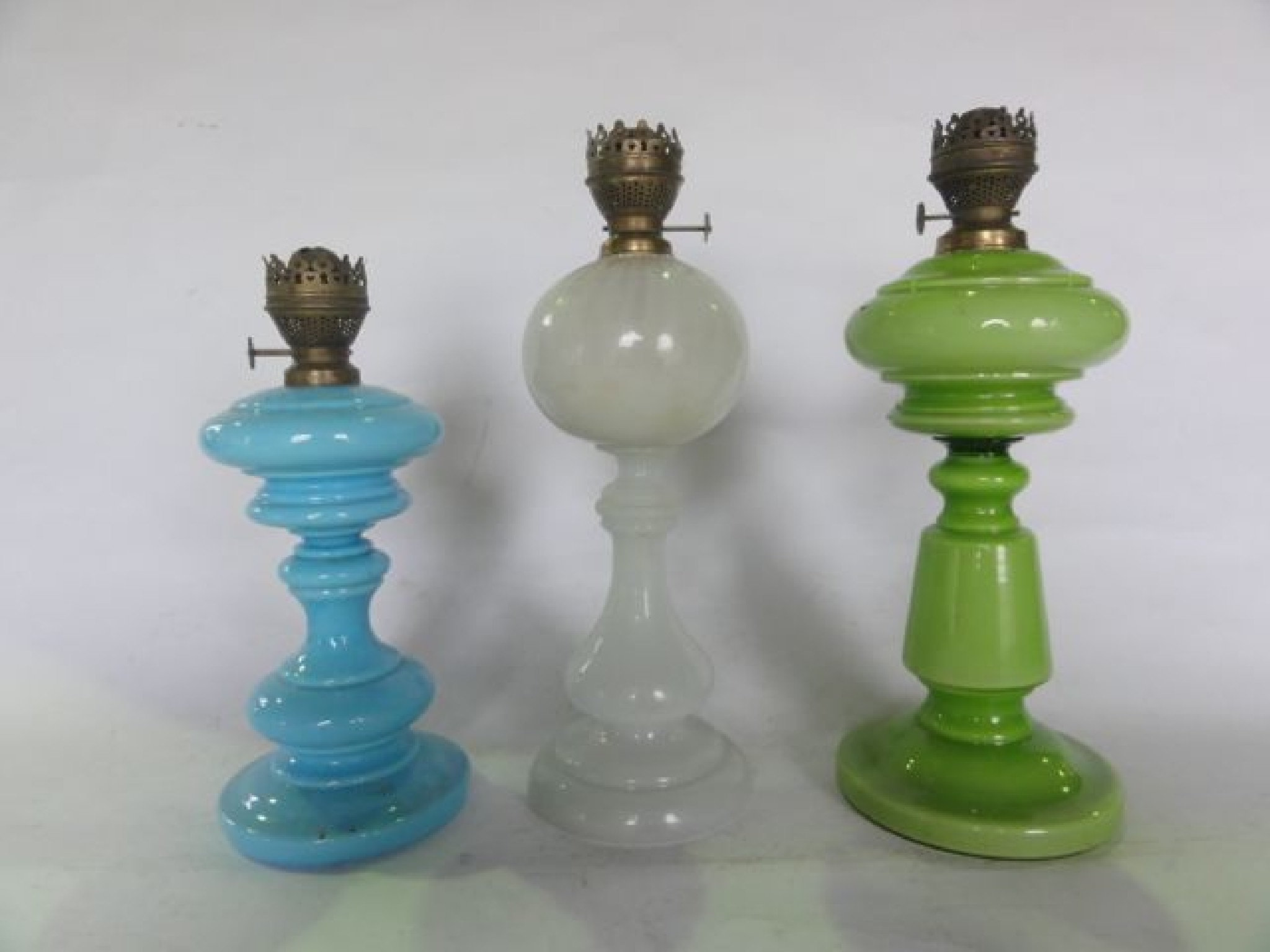 Appraisal: Three Victorian oil lamps all with glass founts stands to