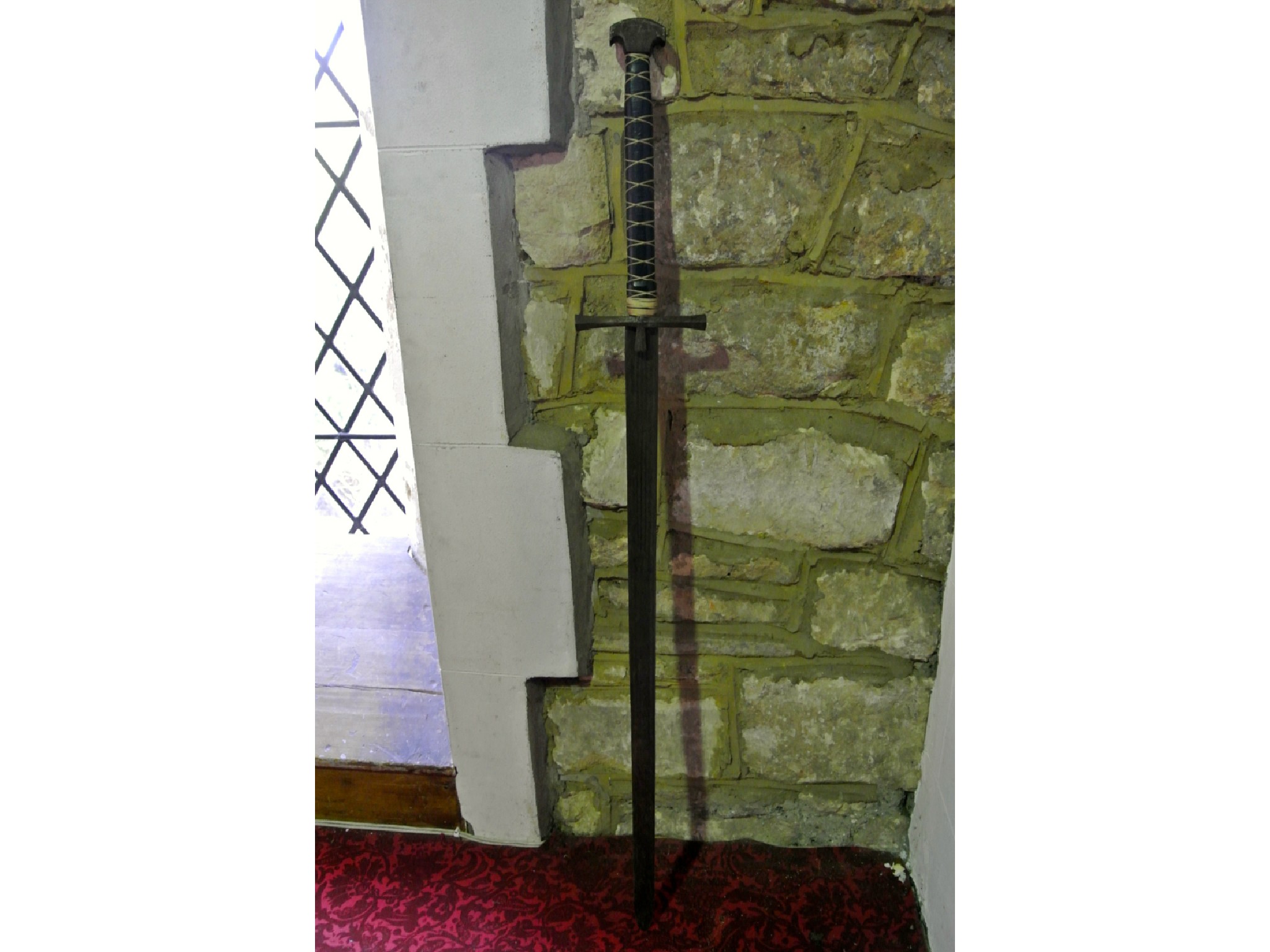 Appraisal: A reproduction replica of a medieval longsword with bound grip