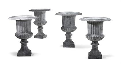 Appraisal: Set of four Neoclassical style cast iron garden urns Each