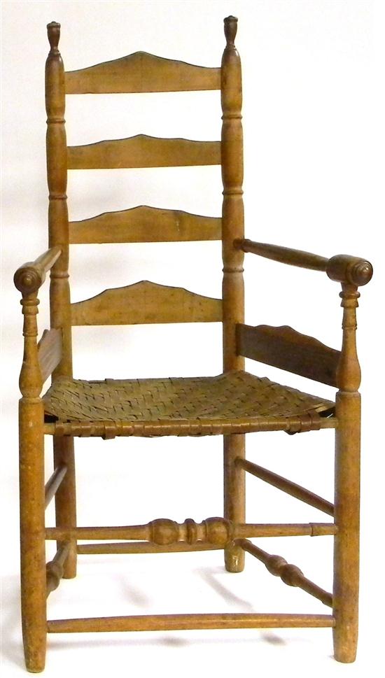 Appraisal: Ladderback arm chair caned seat turned legs bobbin-turned stretcher some