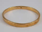 Appraisal: A yellow metal bangle marked ct internal width approx cm