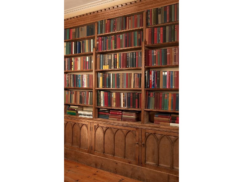 Appraisal: A PINE BOOK CASE in the manner of A W