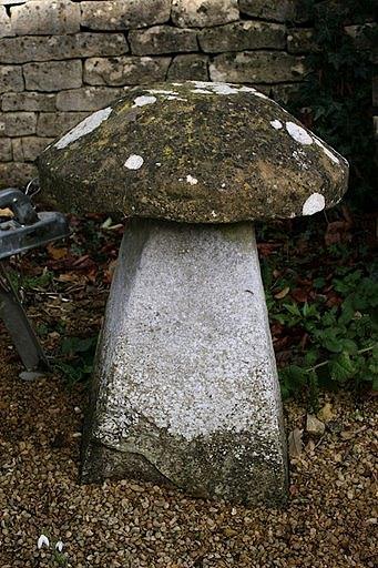 Appraisal: A staddle stone with circular top and a tapered base