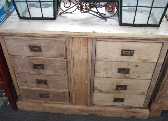 Appraisal: A pine bank of eight short drawers raised on plinth