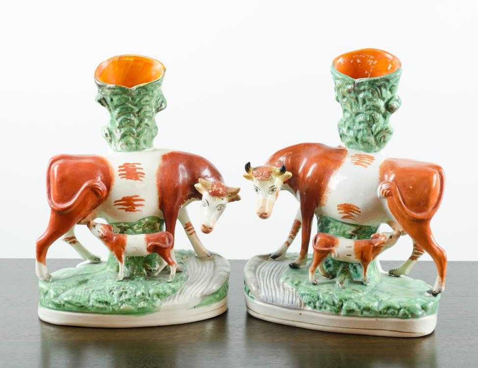 Appraisal: PAIR OF STAFFORDSHIRE PORCELAIN COW SPILL VASES glazed in green