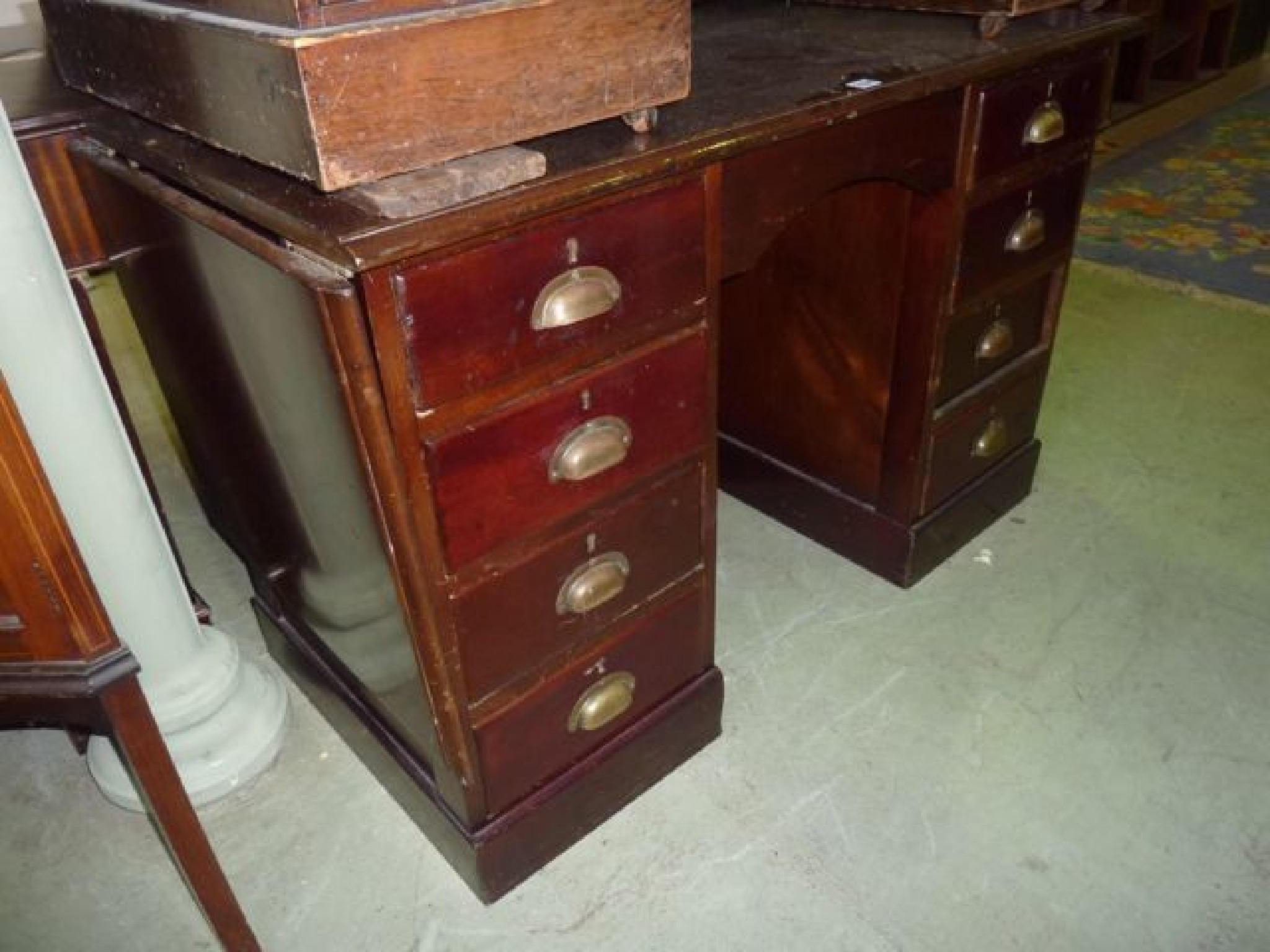 Appraisal: A vintage mahogany kneehole twin pedestal desk of nine drawers