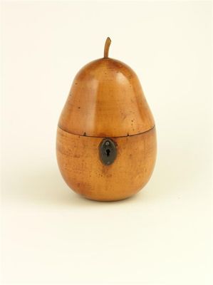 Appraisal: A turned fruitwood pear shape tea caddy with an oval