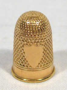 Appraisal: A high carat gold thimble circa