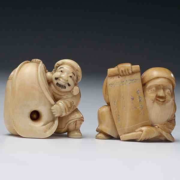 Appraisal: Ivory Netsukes Japanese two carved ivory netsukes each featuring a