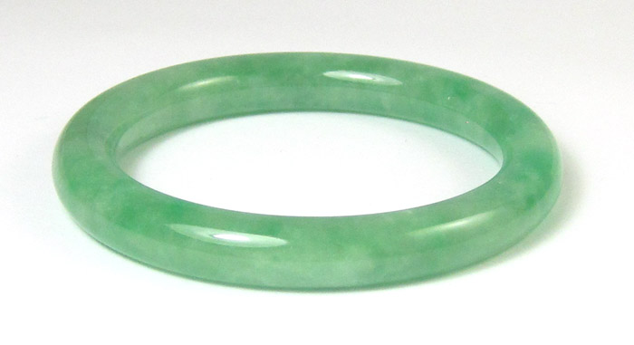 Appraisal: HEAVY GREEN JADE BANGLE The round jade bangle weighs grams