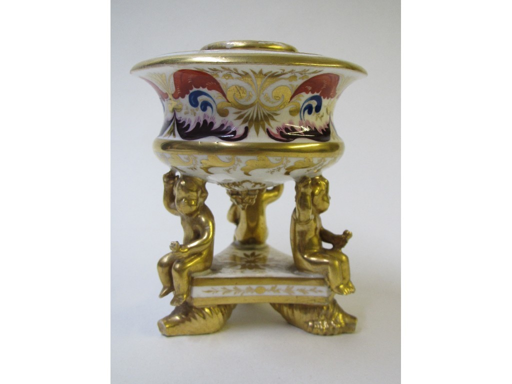 Appraisal: A Derby inkwell modelled with three gilt cherubs supporting a