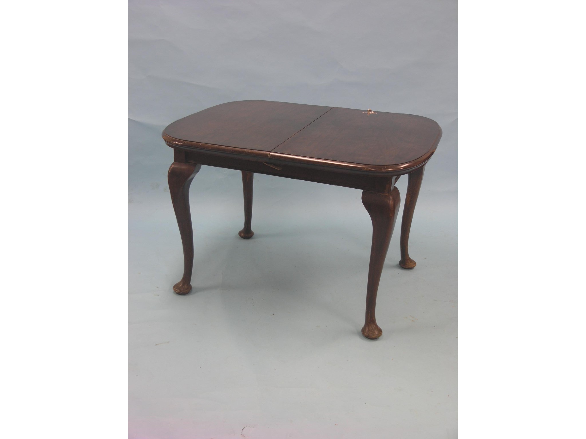 Appraisal: An early th century mahogany dining table with concealed extra