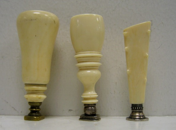 Appraisal: THREE IVORY HANDLED WAX SEALS Two with intaglio crests in