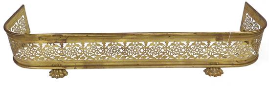 Appraisal: Brass fireplace fender pierced with stylized rose motif on paw