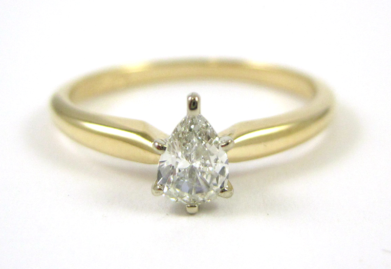 Appraisal: DIAMOND AND FOURTEEN KARAT GOLD SOLITAIRE RING having pear cut