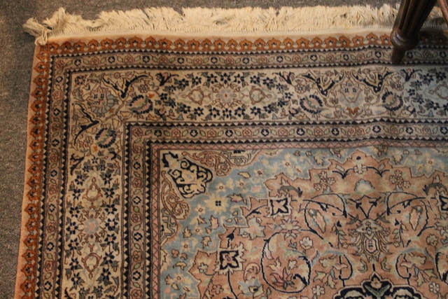 Appraisal: A PERSIAN RUST GROUND RUG with central medallion and allover