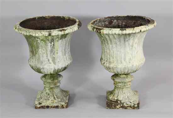 Appraisal: A pair of Victorian cast iron fluted garden urns on