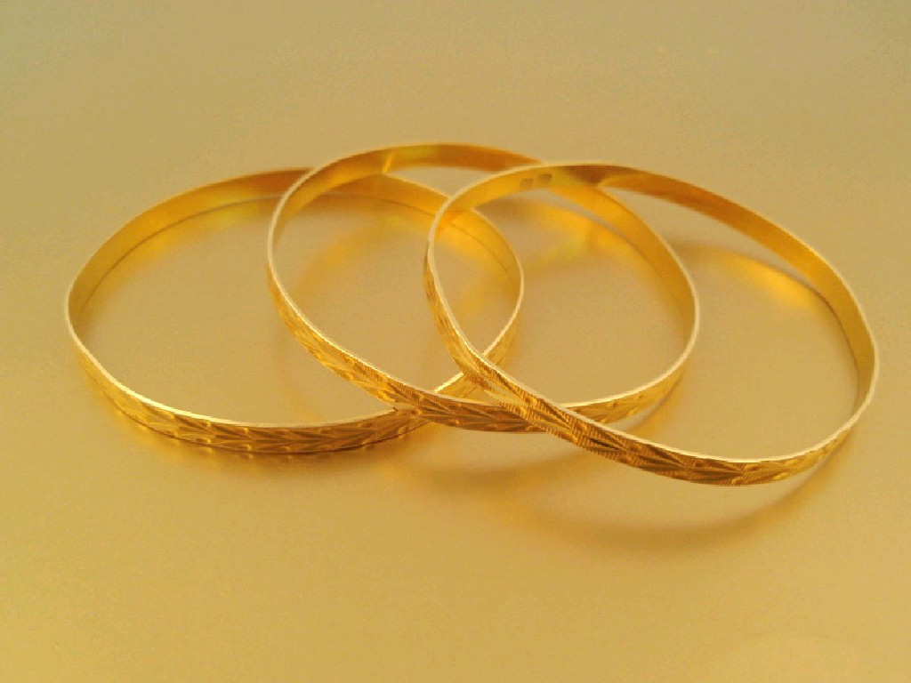 Appraisal: Three matching engraved bangles marked A g all in