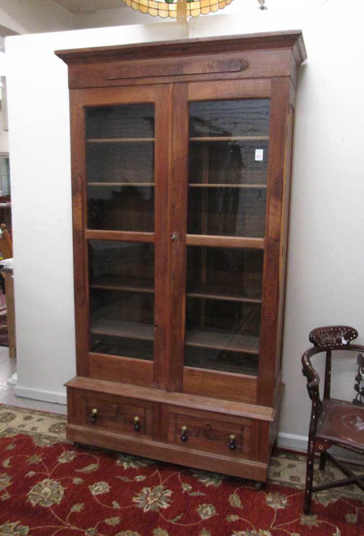 Appraisal: VICTORIAN WALNUT CABINET BOOKCASE ON BASE American last quarter of