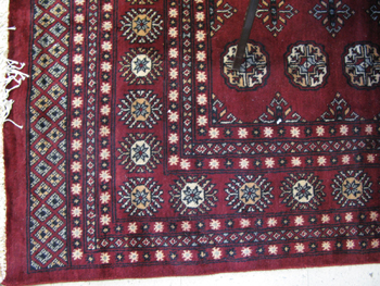 Appraisal: RED PAKISTANI BOKHARA CARPET hand knotted in an overall Turkoman