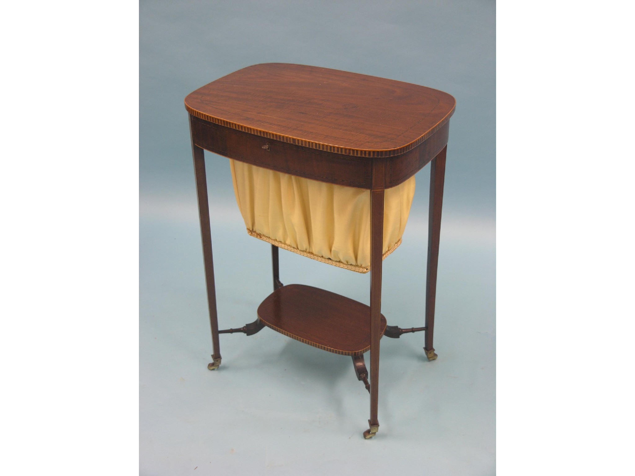 Appraisal: An early Victorian inlaid mahogany work table near-oval fiddle-back top