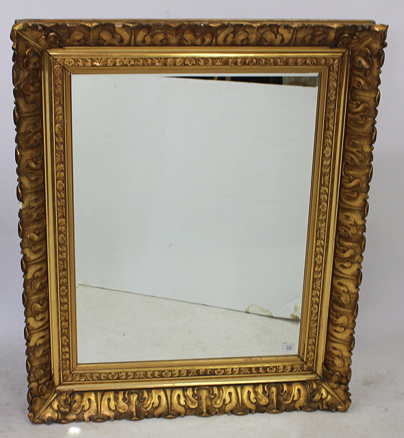 Appraisal: A LARGE RECTANGULAR GILT FRAMED WALL MIRROR with bevelled mirror