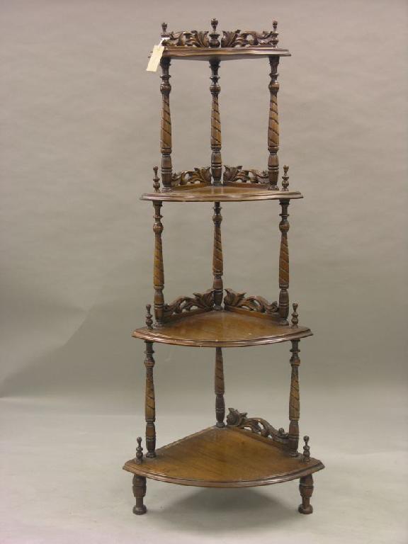 Appraisal: A Victorian style walnut corner fitting whatnot four tiers supported