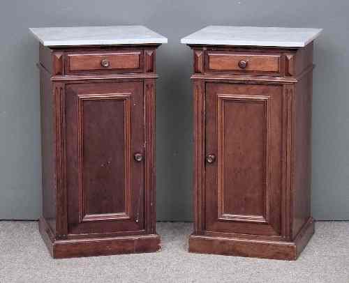 Appraisal: A pair of mahogany bedside cabinets with white marble slabs