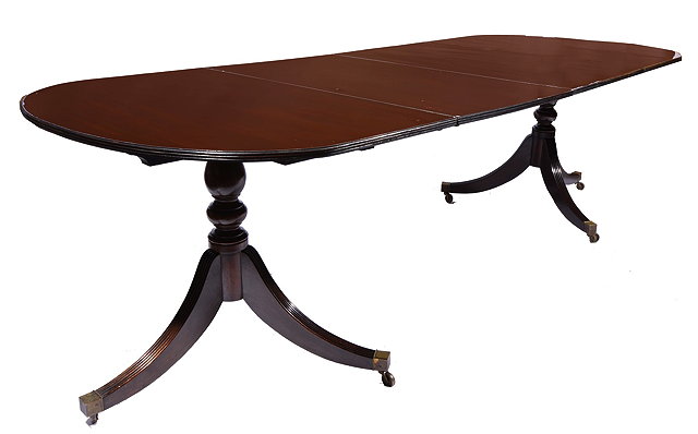 Appraisal: A REGENCY STYLE MAHOGANY 'D' END DINING TABLE with fluted