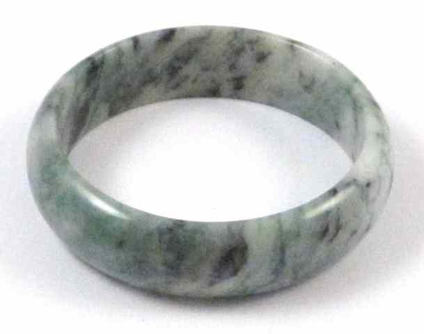 Appraisal: CHINESE GREEN JADE BANGLE round in shape having shades of