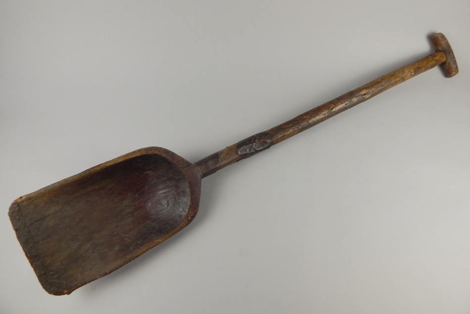 Appraisal: A rustic shovel with metal bands and traces of old