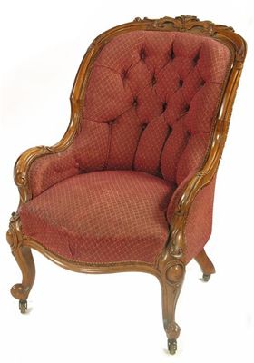 Appraisal: A Victorian carved walnut show frame easy chair with button