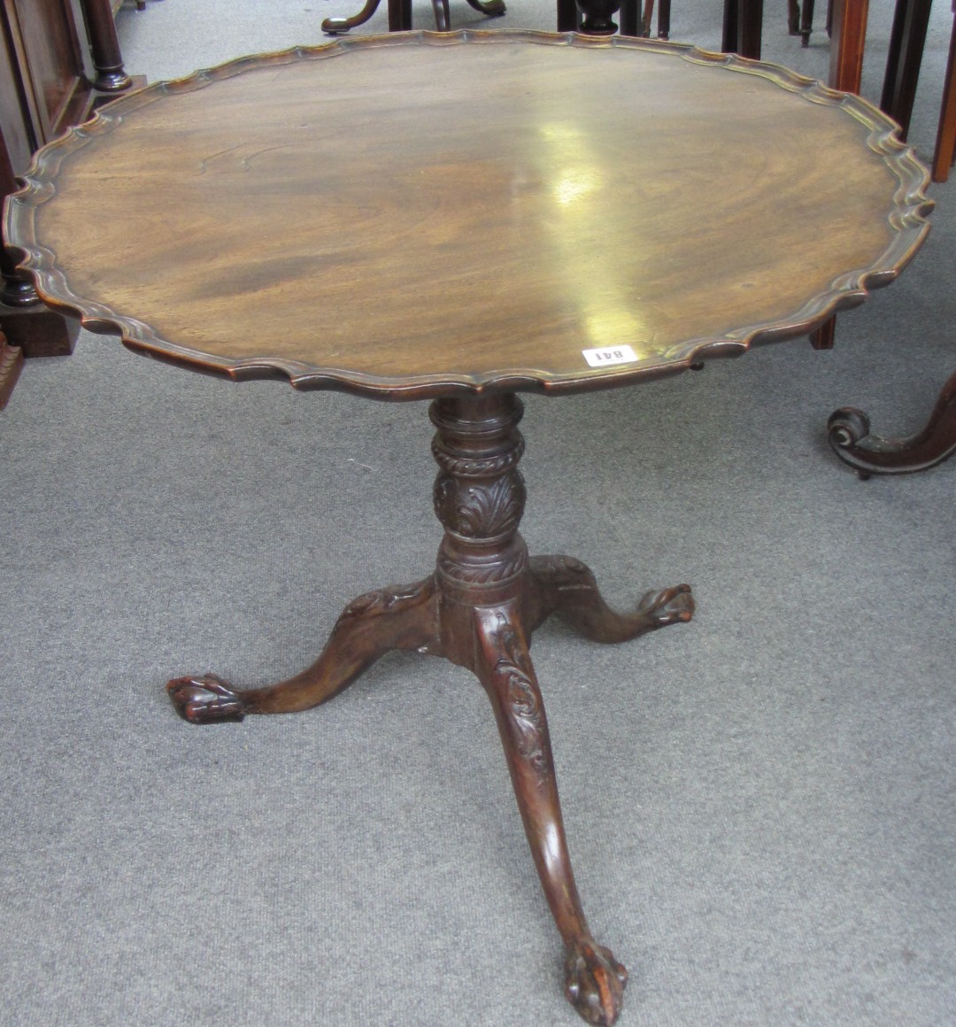 Appraisal: A George III mahogany snap top occasional table the shaped