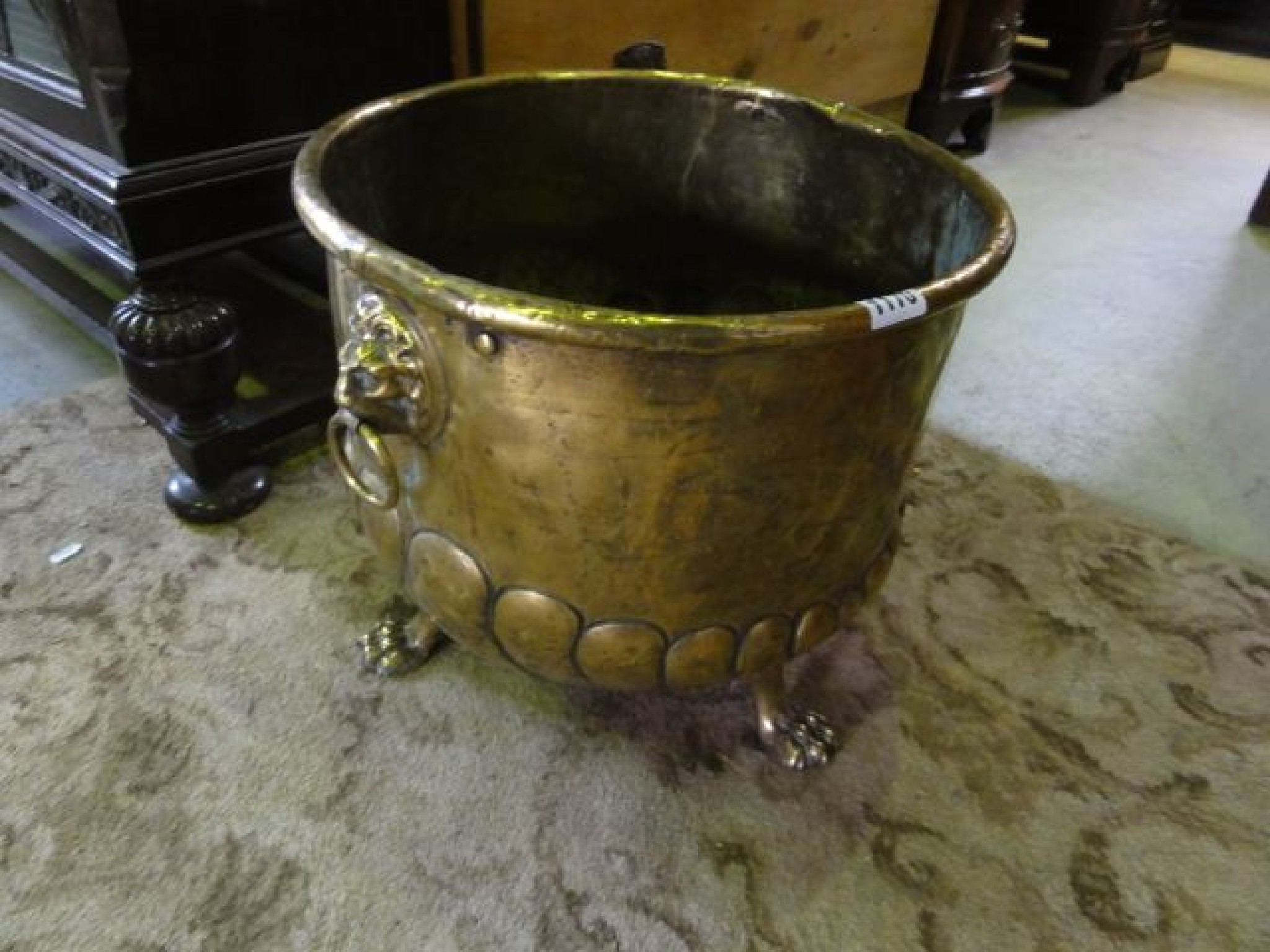 Appraisal: A brass coal bin of circular form with lions mask