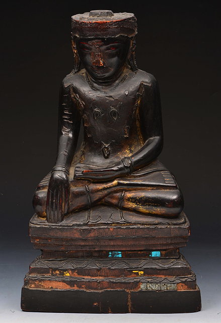 Appraisal: A SOUTH EAST ASIAN CARVED WOODEN FIGURE of Bhudda seated